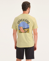 Back view of model wearing 90s Beach Dusty Yellow Men's Slim Fit Logo Tee.