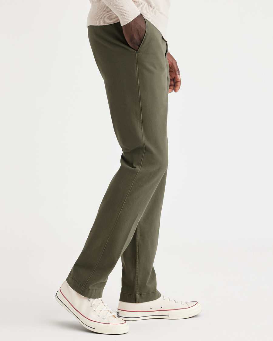 Side view of model wearing Army Green Alpha Chino Pants, Slim Fit.