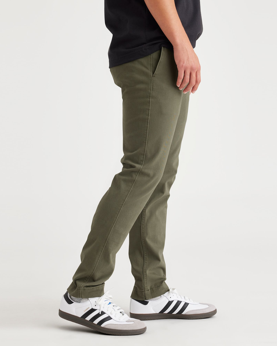 Side view of model wearing Army Green Men's Skinny Fit Smart 360 Flex California Chino Pants.