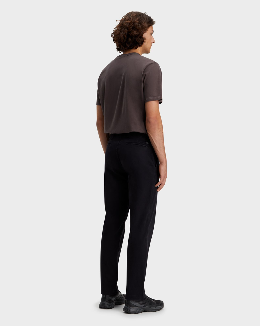 Back view of model wearing Beautiful Black Alpha Chino Pants, Straight Fit.