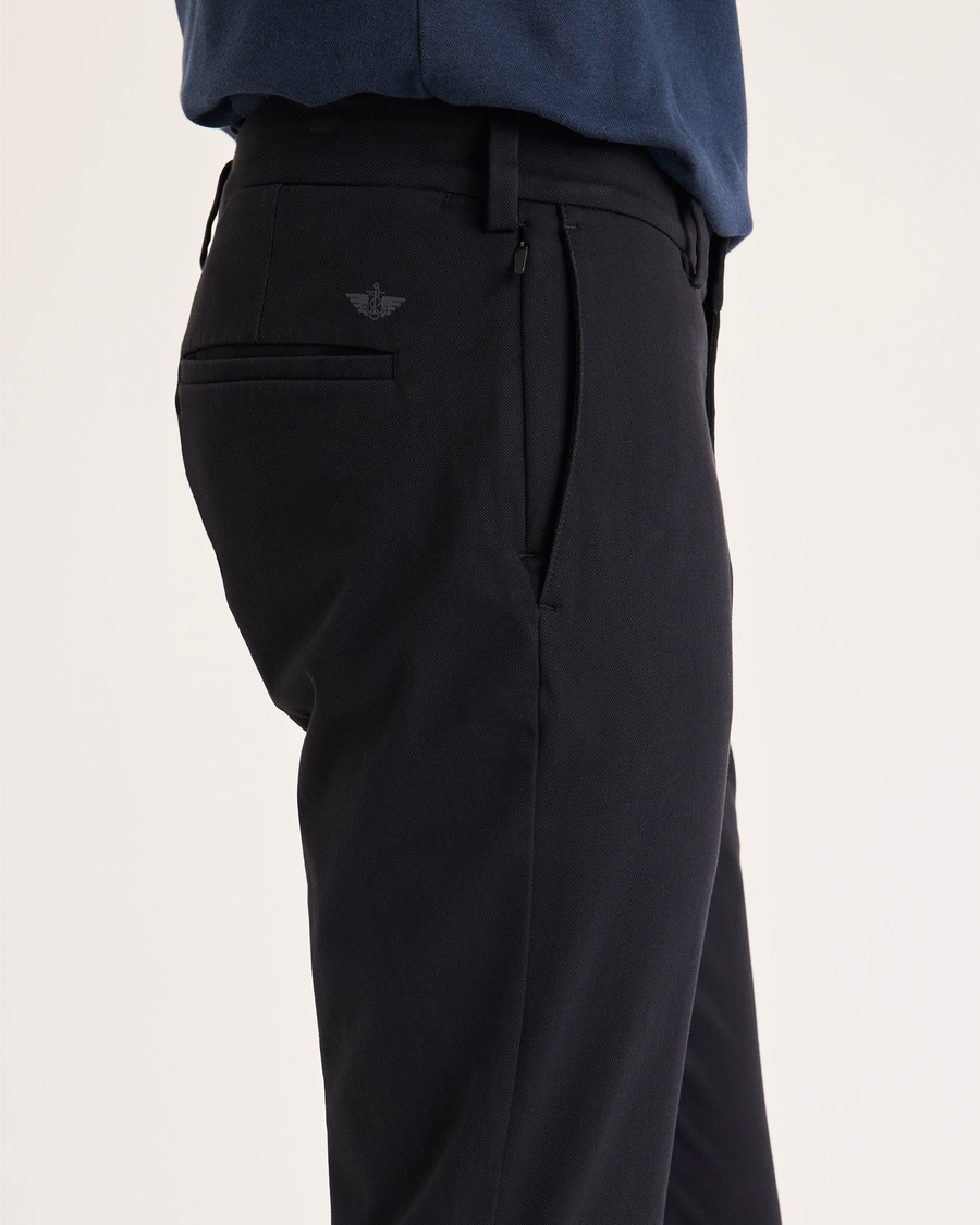 Side view of model wearing Beautiful Black Chino Go Activeflex, fit skinny.