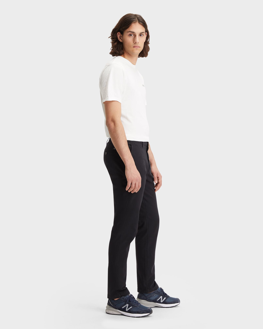 Side view of model wearing Black Crafted Khaki Pants, Slim Fit.