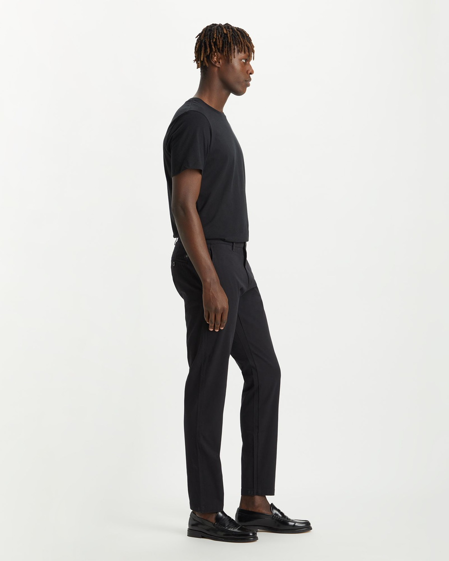 Side view of model wearing Black Crafted Khaki Pants, Slim Tapered Fit.