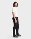 Side view of model wearing Black Men's Slim Fit Smart 360 Flex Alpha Chino Pants.
