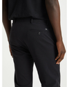 View of model wearing Black Men's Slim Tapered Fit Smart 360 Flex Alpha Chino Pants.