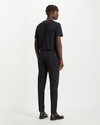 Back view of model wearing Black Men's Slim Tapered Fit Smart 360 Flex Alpha Chino Pants.