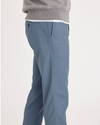 Side view of model wearing Bluefin Men's Slim Fit Original Chino Pants.