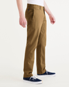 Side view of model wearing Bronze Brown Alpha Chino Pants, Slim Fit.