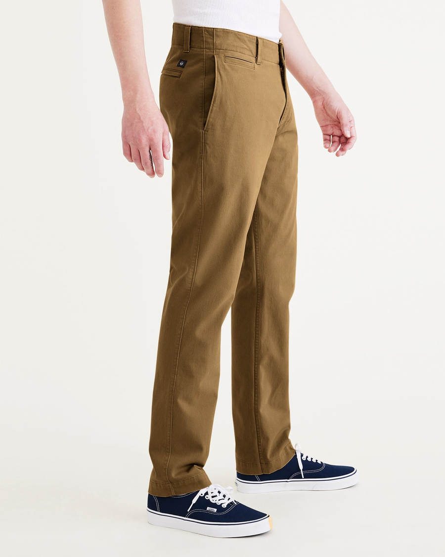 Side view of model wearing Bronze Brown Alpha Chino Pants, Slim Fit.