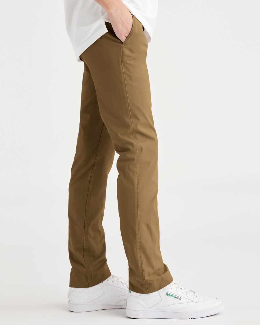 Side view of model wearing Bronze Brown Men's Skinny Fit Smart 360 Flex California Chino Pants.