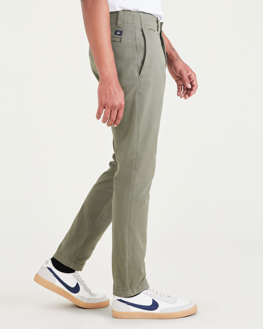 Side view of model wearing Camo Men's Skinny Fit Smart 360 Flex California Chino Pants.