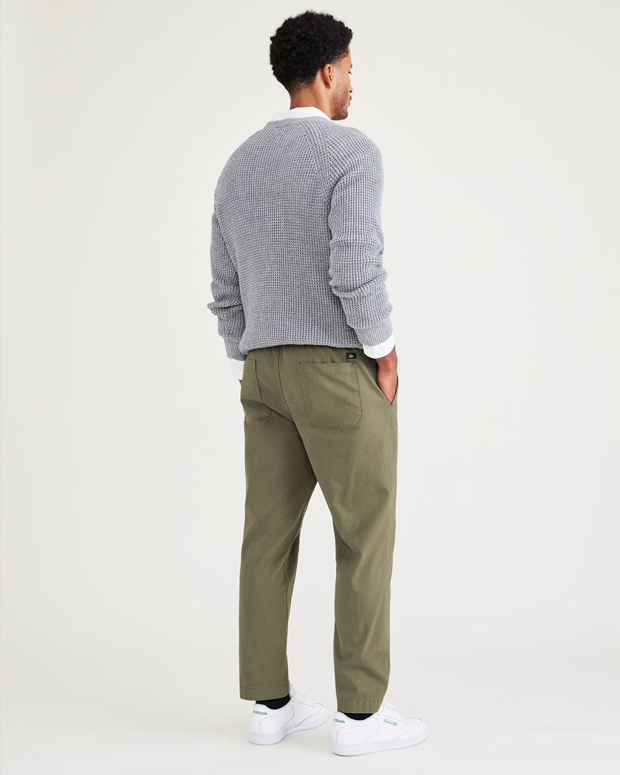 Back view of model wearing Camo Men's Straight Tapered Fit California Pull-On Pants.