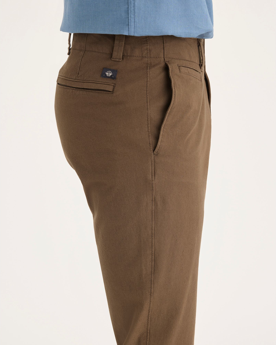 Side view of model wearing Coffee Liquer Alpha Chino Pants, Skinny Fit.