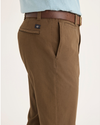 Side view of model wearing Coffee Liquer Alpha Chino Pants, Slim Fit.