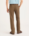 Back view of model wearing Coffee Liquer Men's Slim Fit Smart 360 Flex California Chino Pants.