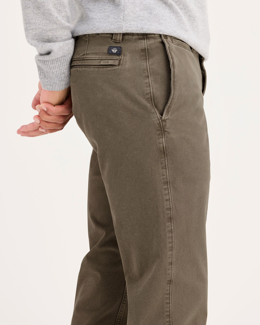 Side view of model wearing Crocodile Stonewash Alpha Chino Pants, Slim Fit.