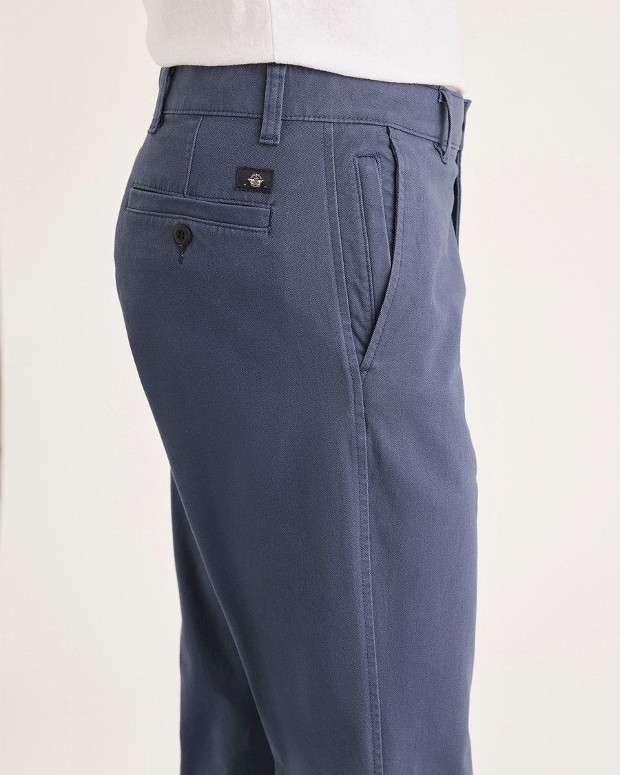 Side view of model wearing Crown Blue Men's Slim Fit Smart 360 Flex Ultimate Chino Pants.