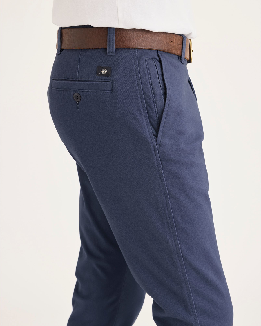 Side view of model wearing Crown Blue Men's Smart 360 Flex Ultimate Chino.