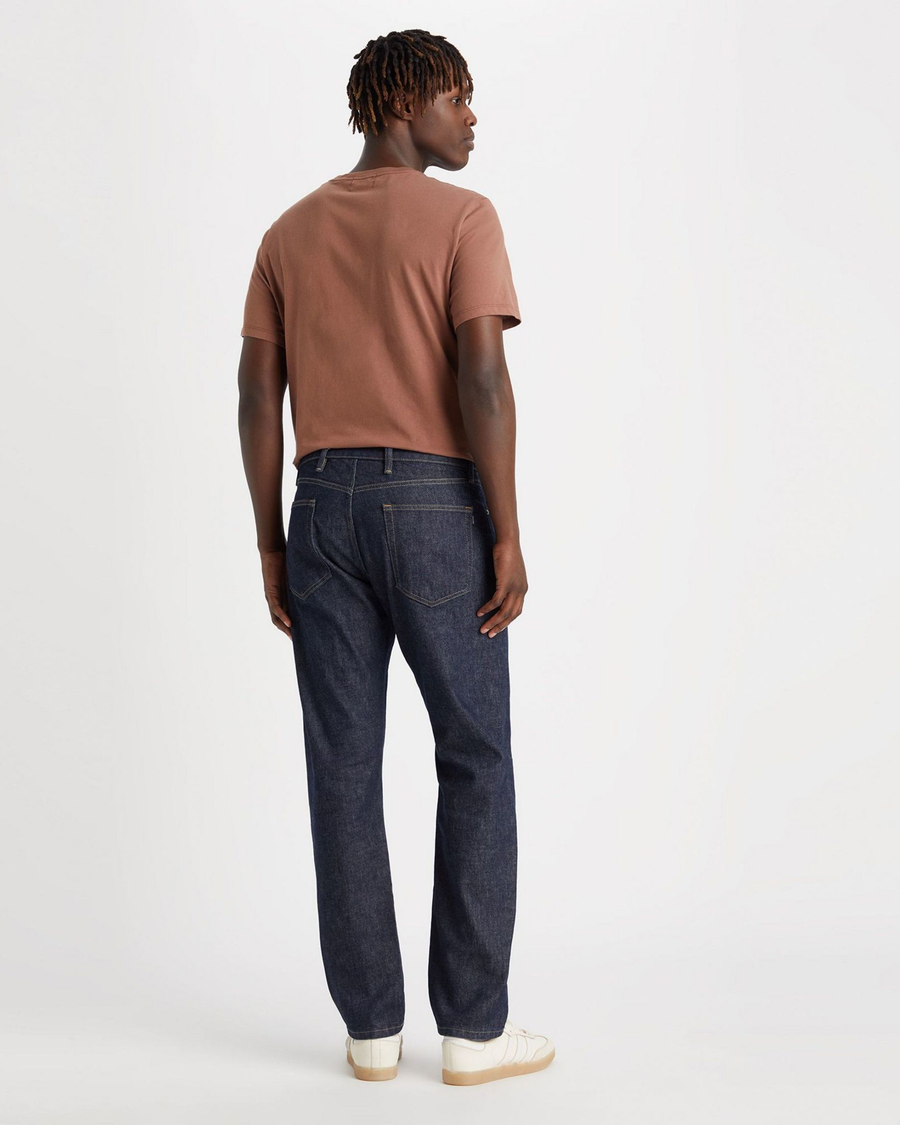 Back view of model wearing Dark Indigo Rinse Men's Slim Fit Smart 360 Flex Jean Cut Pants.