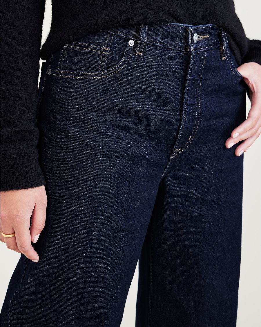View of model wearing Dark Indigo Stonewash Women's Relaxed Fit Mid-Rise Jeans.