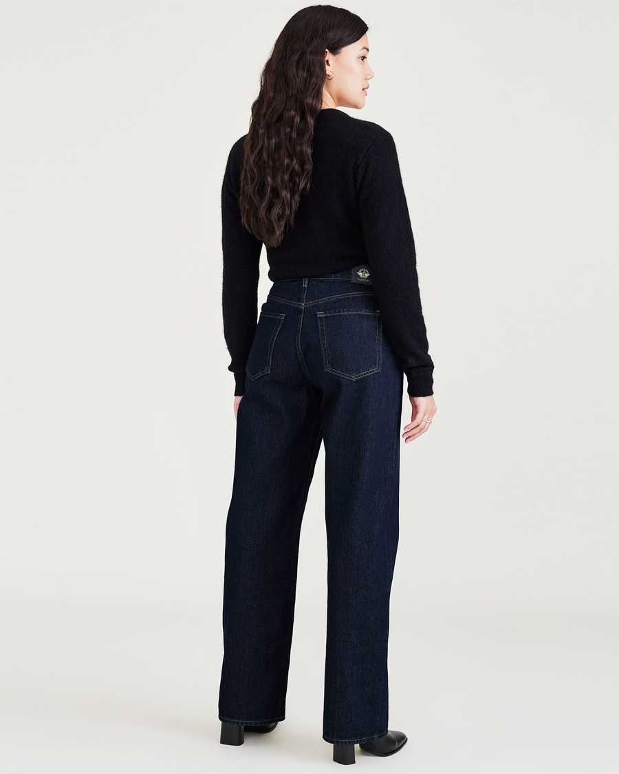 Back view of model wearing Dark Indigo Stonewash Women's Relaxed Fit Mid-Rise Jeans.