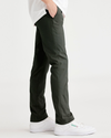 Side view of model wearing Deep Forest Alpha Chino Pants, Skinny Fit.