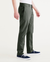 Side view of model wearing Deep Forest Alpha Chino Pants, Slim Fit.