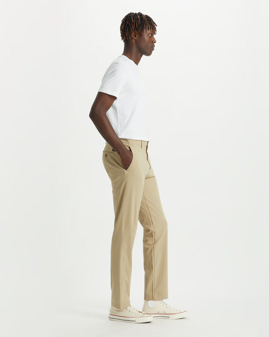 Side view of model wearing Dockers Khaki Crafted Khaki Pants, Slim Fit.