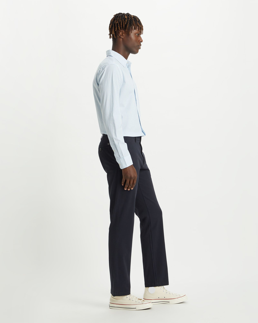 Side view of model wearing Dockers Navy Crafted Khaki Pants, Slim Fit.