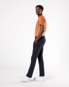 Side view of model wearing Dockers Navy Men's Skinny Fit Supreme Flex Alpha Khaki Pants.