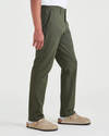 Side view of model wearing Dockers Olive Crafted Khaki Pants, Slim Fit.