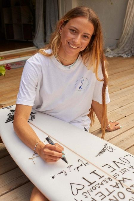 Maud Le Car signing surf board