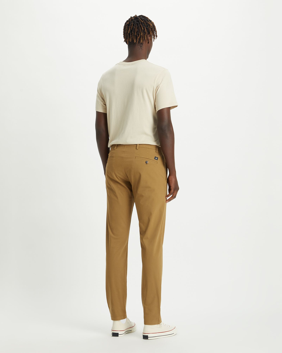 Back view of model wearing Ermine Men's Slim Tapered Fit Smart 360 Flex Alpha Chino Pants.