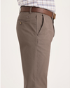 Side view of model wearing Fossil Men's Slim Fit Smart 360 Flex Alpha Chino Pants.