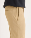 Side view of model wearing Harvest Gold Go Activeflex Chino, Skinny Fit.