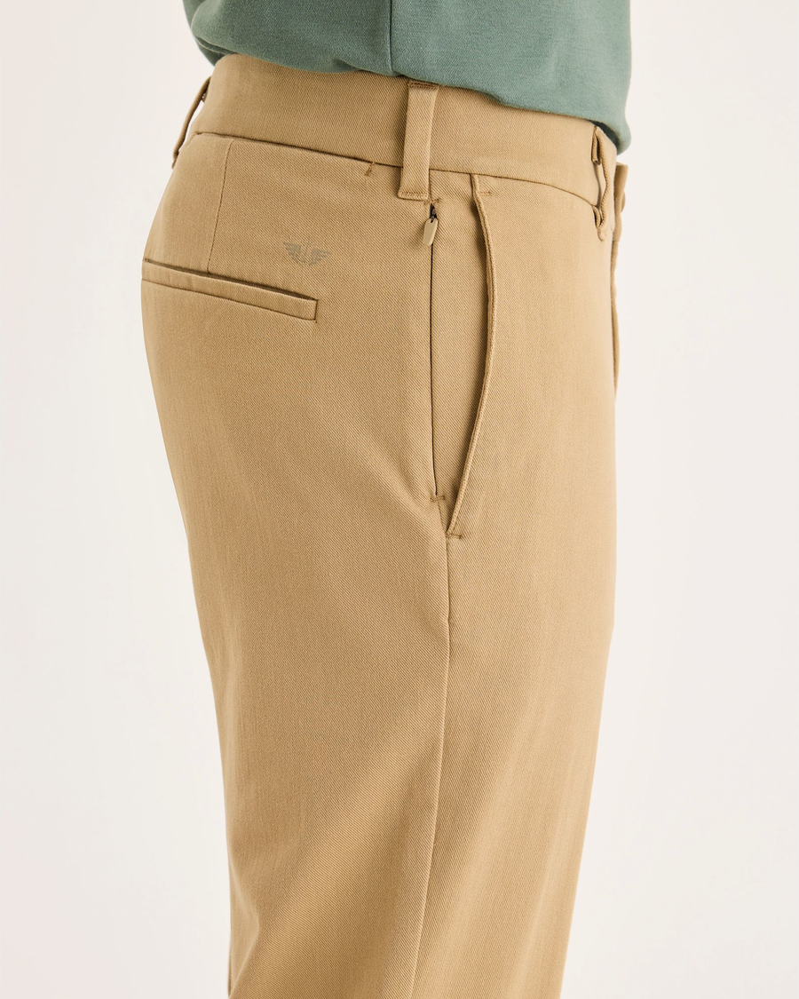 Side view of model wearing Harvest Gold Go Activeflex Chino, Slim Fit.