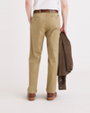 Back view of model wearing Harvest Gold Men's Relaxed Tapered Fit Original Chino Pants.