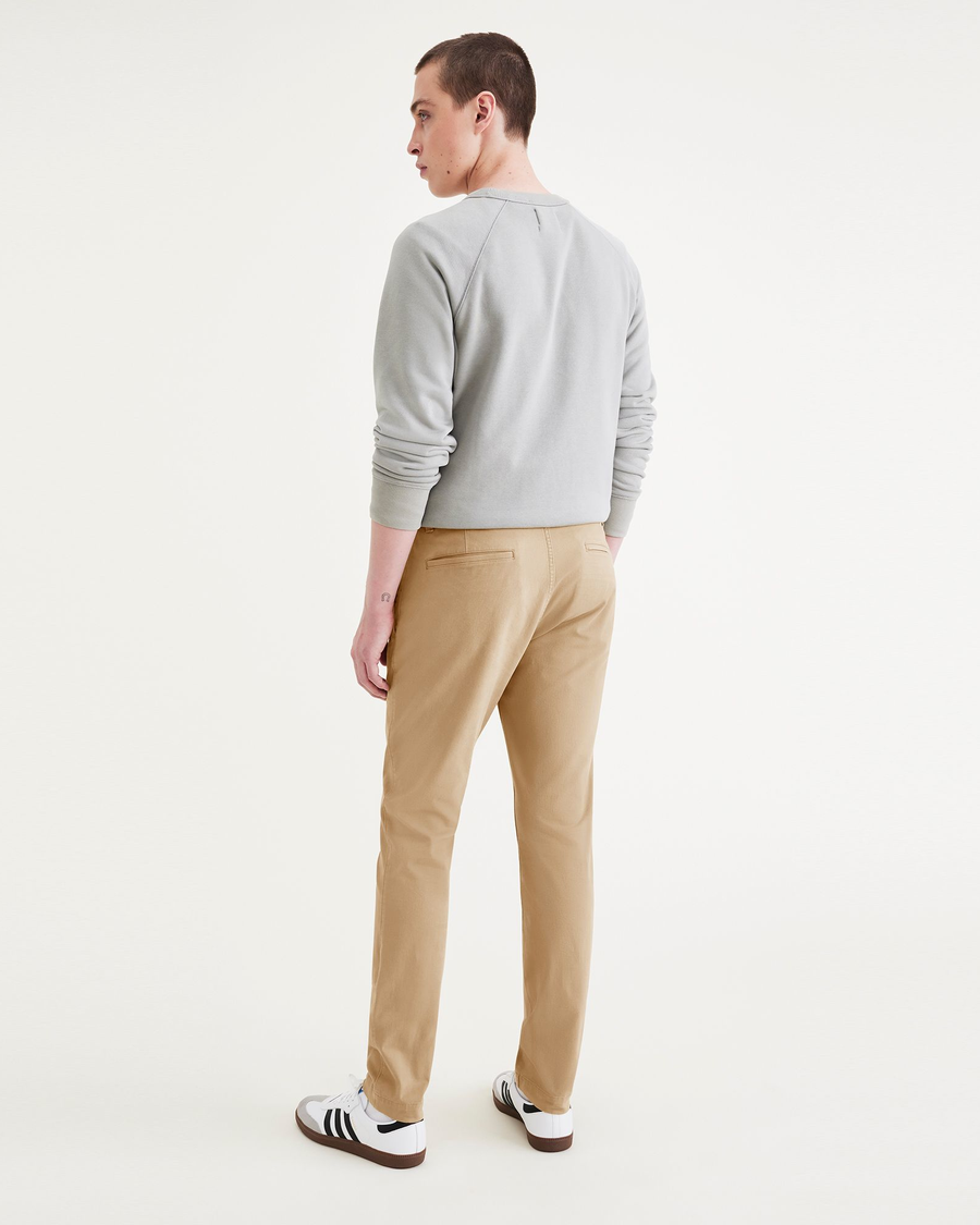 Back view of model wearing Harvest Gold Men's Skinny Fit Smart 360 Flex California Chino Pants.