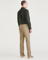 Back view of model wearing Harvest Gold Men's Slim Fit Original Chino Pants.