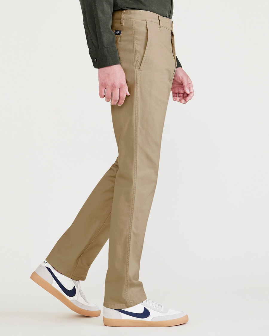 Side view of model wearing Harvest Gold Men's Slim Fit Original Chino Pants.