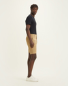 Side view of model wearing Harvest Gold Men's Supreme Flex Modern Chino Short.