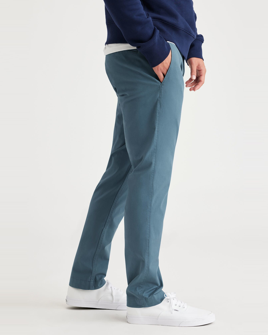 Side view of model wearing Indian Teal Alpha Chino Pants, Skinny Fit.