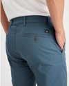 View of model wearing Indian Teal Men's Skinny Fit Original Chino Pants.