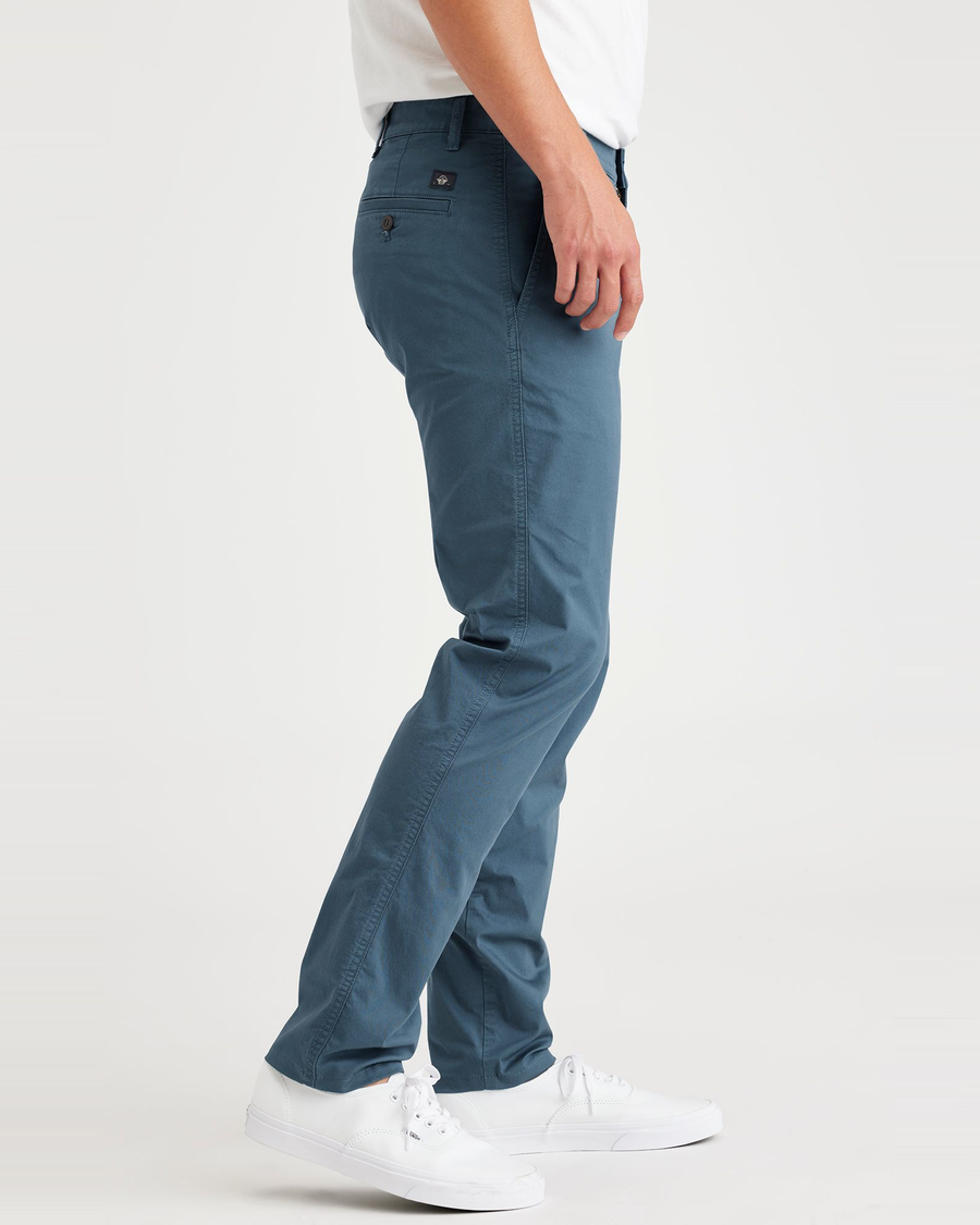Side view of model wearing Indian Teal Men's Skinny Fit Original Chino Pants.