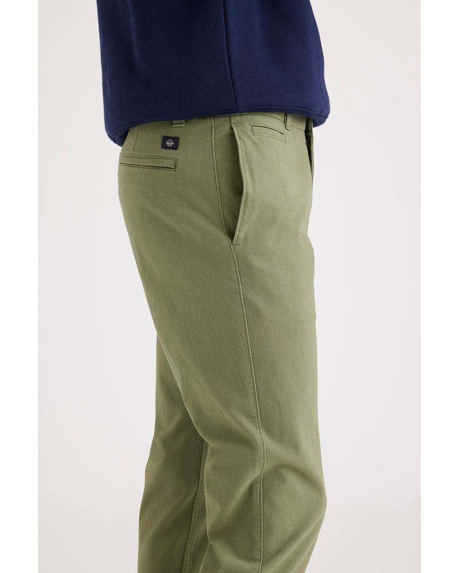 Side view of model wearing Loden Green Alpha Chino Pants, Slim Fit.