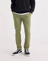 Front view of model wearing Loden Green Men's Skinny Fit Smart 360 Flex California Chino Pants.