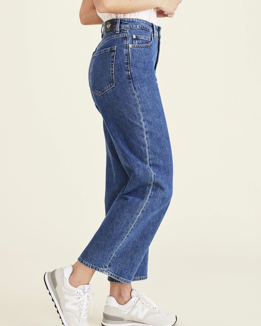 Side view of model wearing Medium Indigo Stonewash Women's Straight Fit High Jean Cut Pants.