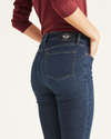 View of model wearing Moonlight Dark Rinse Women's Mid-Rise Skinny Jean Cut Pants.