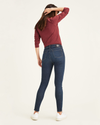 Back view of model wearing Moonlight Dark Rinse Women's Mid-Rise Skinny Jean Cut Pants.