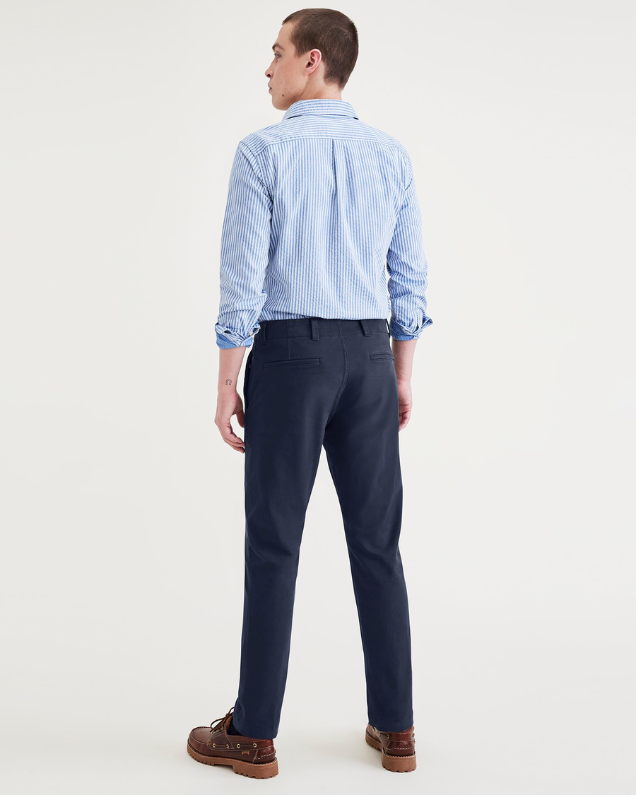 Back view of model wearing Navy Blazer Alpha Chino Pants, Slim Fit.